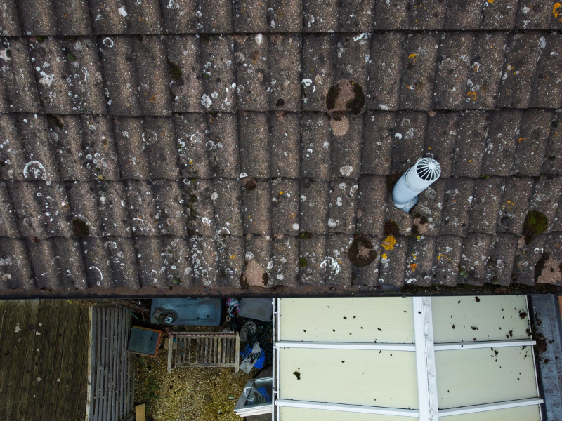 Aerial view of roof tiles and a roof vent during a drone inspection