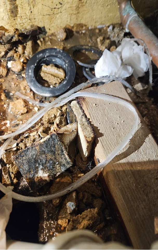 plumbing-leak-timber-decay Corroded pipe fittings and decayed timber caused by a plumbing leak