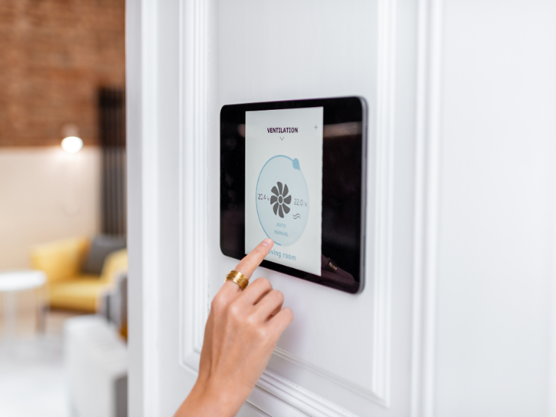 A smart ventilation control panel showing humidity and temperature readings for a room