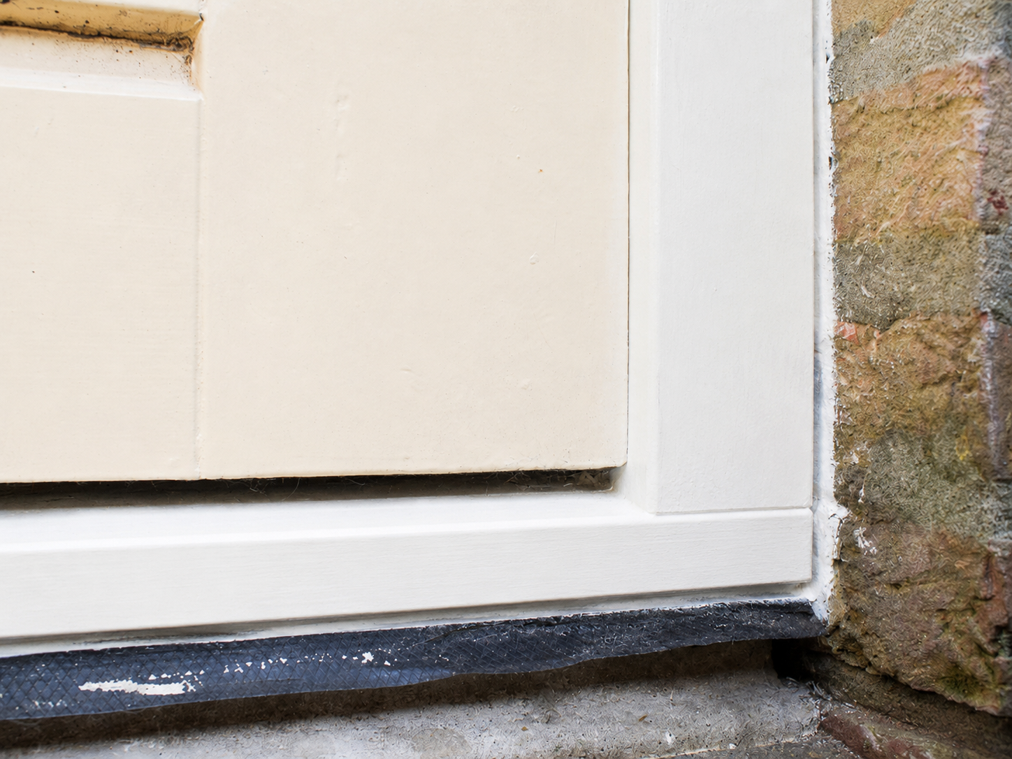 wood-rot-door-frame-after-repair Exterior wooden door frame repaired and repainted following wood rot treatment